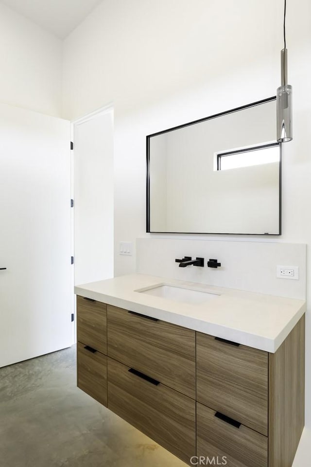 bathroom with finished concrete floors and vanity