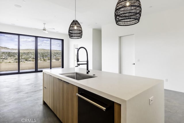 kitchen with a kitchen island with sink, modern cabinets, a sink, light countertops, and dishwashing machine