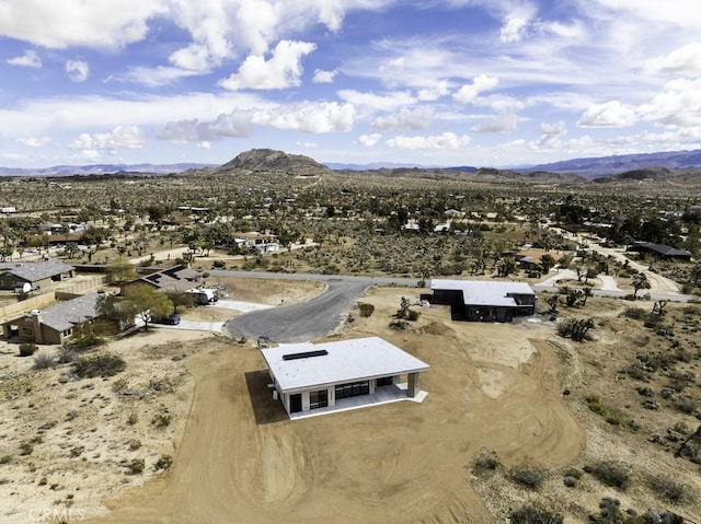 drone / aerial view featuring a mountain view and view of desert