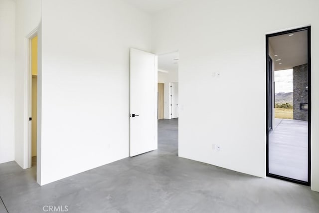 unfurnished bedroom with concrete flooring