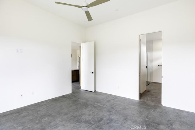 unfurnished bedroom featuring ceiling fan and finished concrete flooring