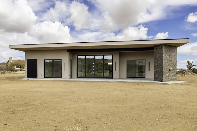 back of house with a patio area and stucco siding
