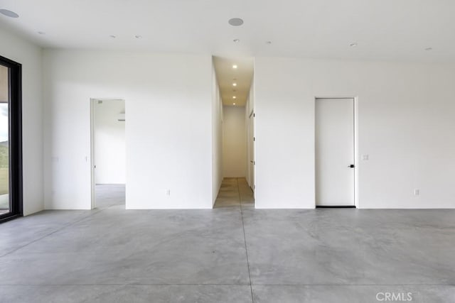unfurnished room featuring recessed lighting and finished concrete floors