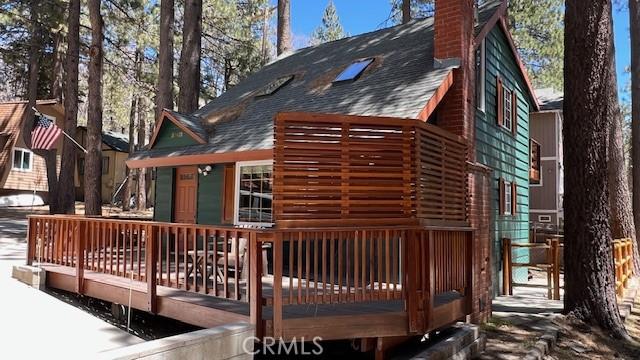 33411 Weeping Willow Dr, Green Valley Lake, CA 92341 - back of property with a shingled roof, a chimney, and a wooden deck