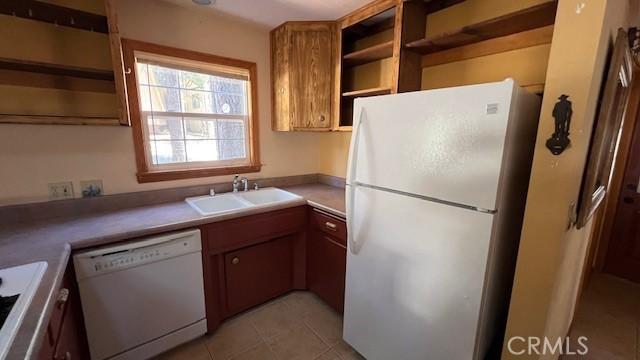 33411 Weeping Willow Dr, Green Valley Lake, CA 92341 - kitchen featuring white appliances, open shelves, a sink, brown cabinets, and light tile patterned floors