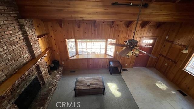 33411 Weeping Willow Dr, Green Valley Lake, CA 92341 - unfurnished living room with wooden walls, ceiling fan, and a fireplace with raised hearth