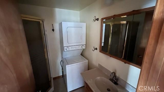 33411 Weeping Willow Dr, Green Valley Lake, CA 92341 - bathroom with stacked washer / dryer, a shower stall, and vanity