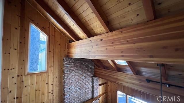 33411 Weeping Willow Dr, Green Valley Lake, CA 92341 - additional living space with a skylight, wooden ceiling, wood walls, and plenty of natural light