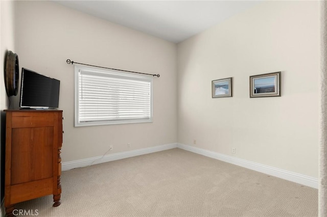 unfurnished bedroom with light colored carpet and baseboards