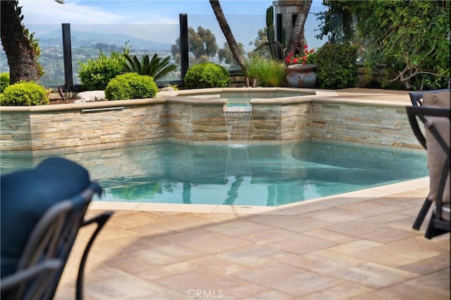 view of pool with a mountain view and a pool with connected hot tub