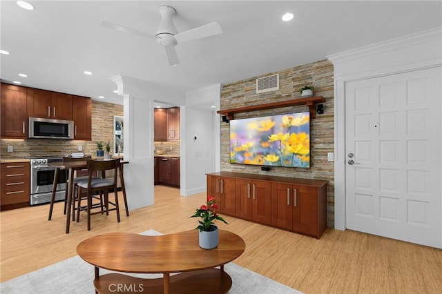 living area with ceiling fan, recessed lighting, light wood-style flooring, and visible vents