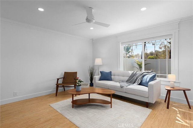 living room with ceiling fan, baseboards, light wood finished floors, ornamental molding, and recessed lighting