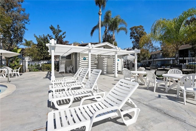 view of patio with a pergola, fence, and outdoor dining space