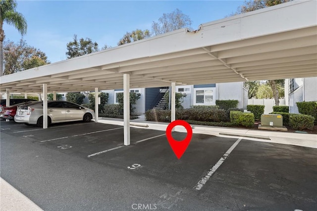 covered parking lot with fence and stairway