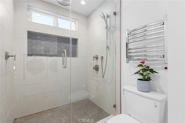 bathroom featuring recessed lighting, radiator, toilet, and a shower stall