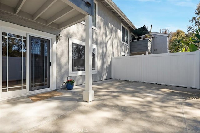 view of home's exterior featuring a patio, fence, and stucco siding