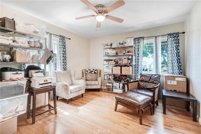 sitting room with ceiling fan and wood finished floors