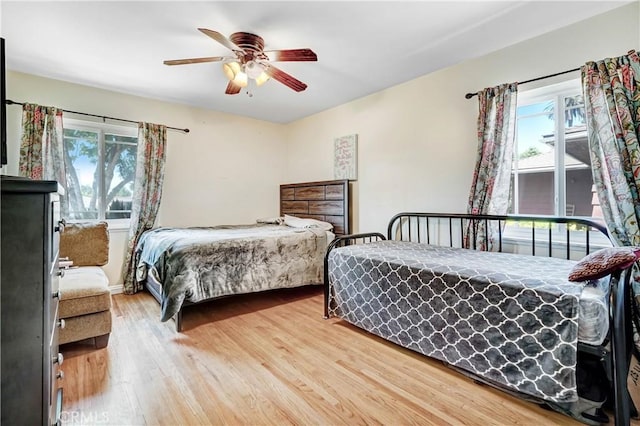 bedroom with a ceiling fan and wood finished floors
