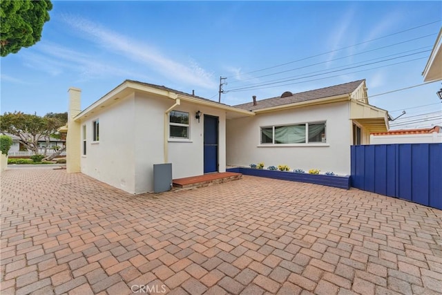 544 Calle Mayor, Redondo Beach, CA 90277 - rear view of property featuring stucco siding, a patio area, and a chimney