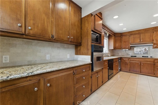 544 Calle Mayor, Redondo Beach, CA 90277 - kitchen featuring black appliances, brown cabinets, backsplash, light tile patterned floors, and recessed lighting