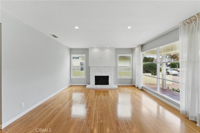544 Calle Mayor, Redondo Beach, CA 90277 - unfurnished living room with plenty of natural light, light wood-type flooring, a fireplace with raised hearth, and recessed lighting