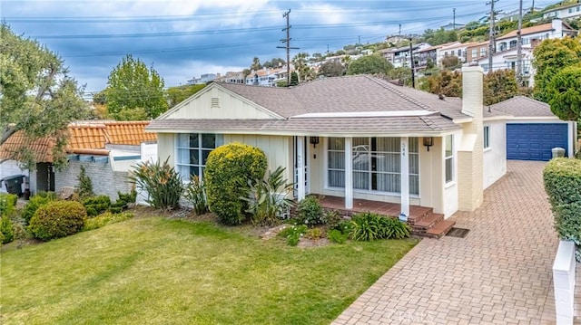 544 Calle Mayor, Redondo Beach, CA 90277 - view of front of house featuring covered porch, a garage, a front lawn, and a shingled roof