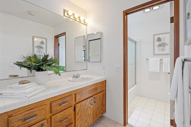 full bath featuring tile patterned floors, enclosed tub / shower combo, and vanity