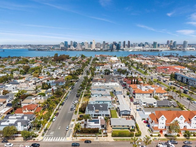 aerial view featuring a water view, a residential view, and a city view