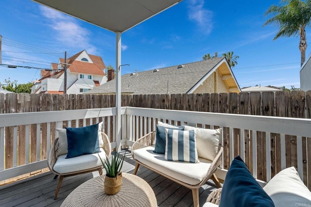 wooden terrace with outdoor lounge area and a fenced backyard