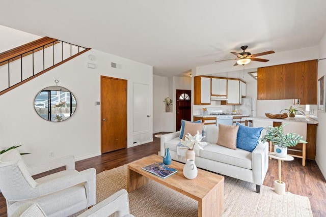 living area featuring baseboards, a ceiling fan, wood finished floors, and visible vents