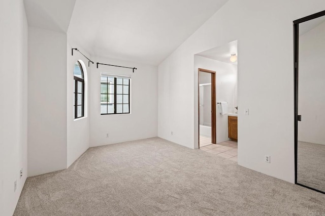 empty room with lofted ceiling and carpet