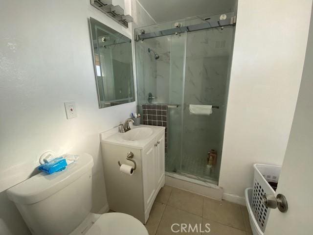 full bathroom featuring tile patterned flooring, a stall shower, toilet, and vanity