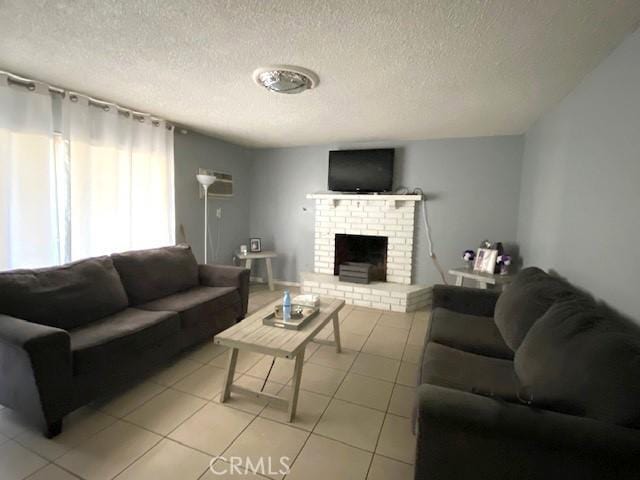 living room featuring a textured ceiling, a brick fireplace, and light tile patterned floors