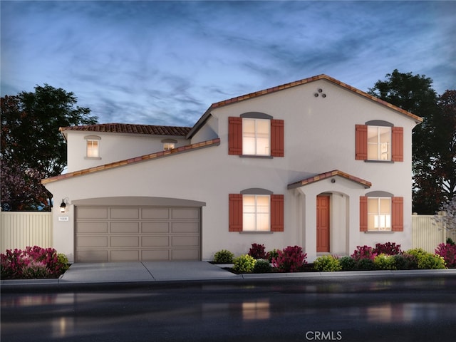 mediterranean / spanish-style house with stucco siding, fence, and concrete driveway