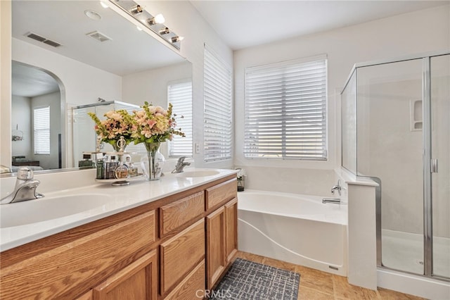 2081 Tangerine Ave, Madera, CA 93637 - bathroom with plenty of natural light, a stall shower, a bath, and double vanity