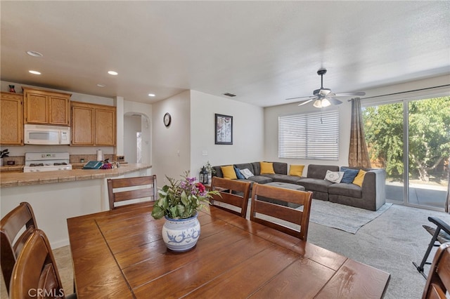2081 Tangerine Ave, Madera, CA 93637 - dining space with arched walkways, recessed lighting, ceiling fan, and light carpet