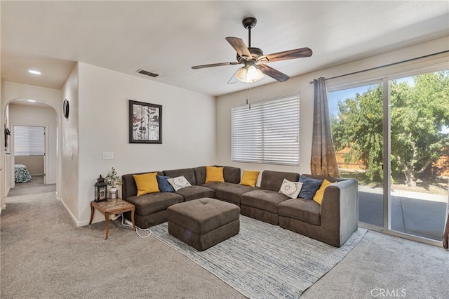 2081 Tangerine Ave, Madera, CA 93637 - carpeted living room with arched walkways, ceiling fan, baseboards, and recessed lighting