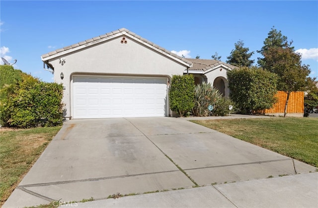 2081 Tangerine Ave, Madera, CA 93637 - view of front facade featuring a garage, stucco siding, concrete driveway, and a tile roof