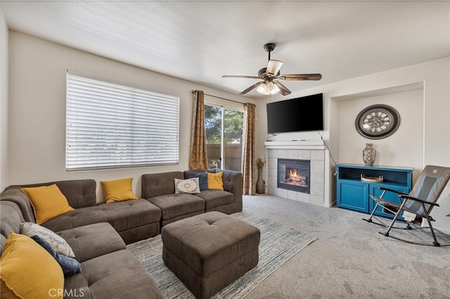 2081 Tangerine Ave, Madera, CA 93637 - living room featuring carpet flooring, a ceiling fan, and a tiled fireplace