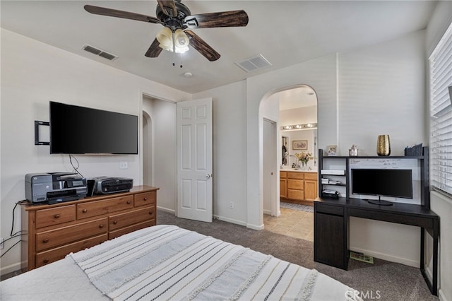 2081 Tangerine Ave, Madera, CA 93637 - bedroom featuring arched walkways, carpet flooring, baseboards, and ensuite bath