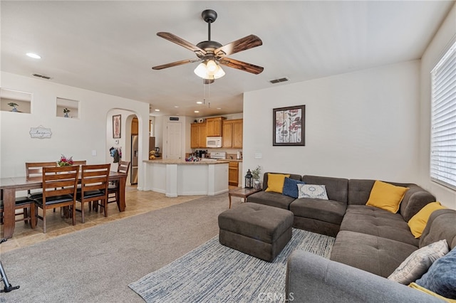 2081 Tangerine Ave, Madera, CA 93637 - living area featuring arched walkways, ceiling fan, plenty of natural light, recessed lighting, and light colored carpet