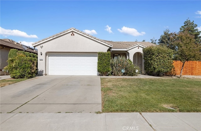 2081 Tangerine Ave, Madera, CA 93637 - view of front of property featuring an attached garage, stucco siding, driveway, and a tiled roof