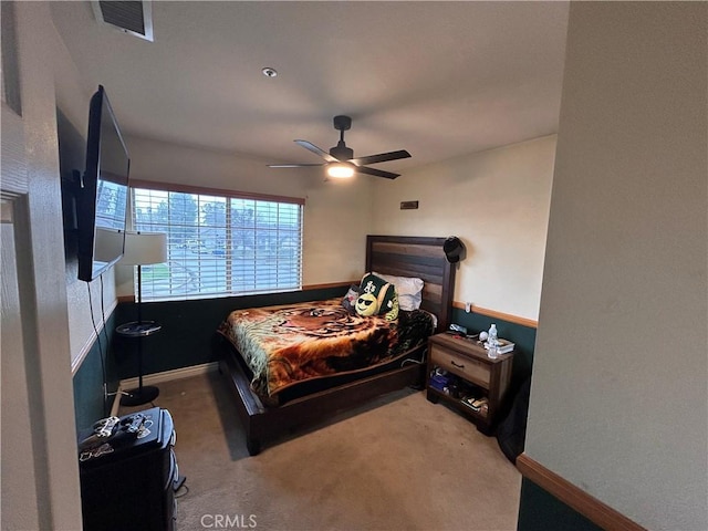 carpeted bedroom with baseboards, a ceiling fan, and visible vents