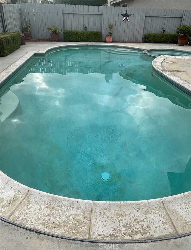view of pool featuring a fenced in pool and fence