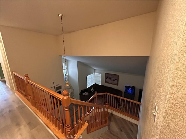 stairway featuring wood finished floors