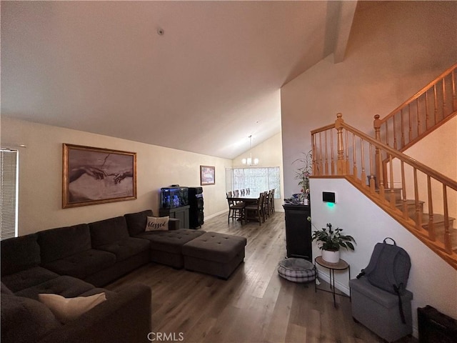 living area featuring an inviting chandelier, wood finished floors, baseboards, high vaulted ceiling, and stairway