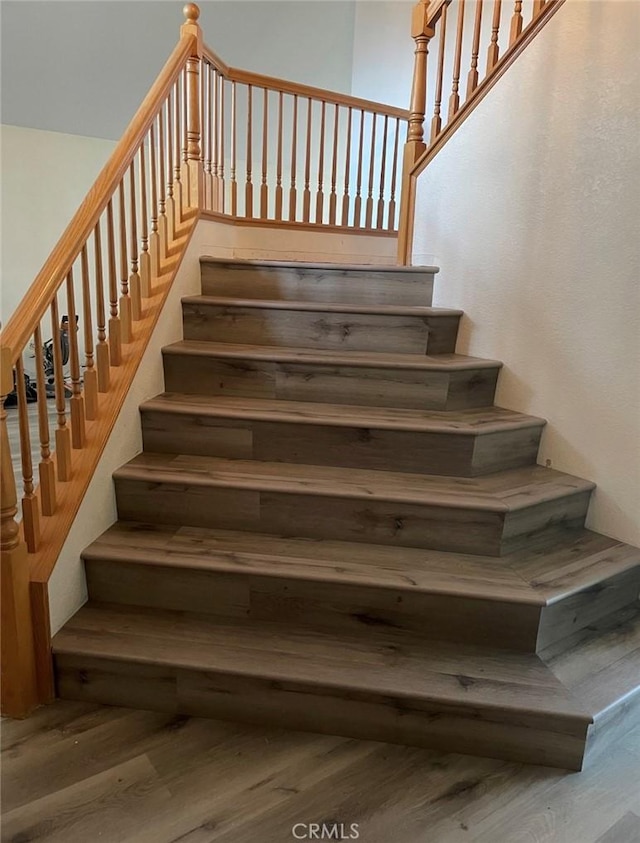 staircase featuring wood finished floors