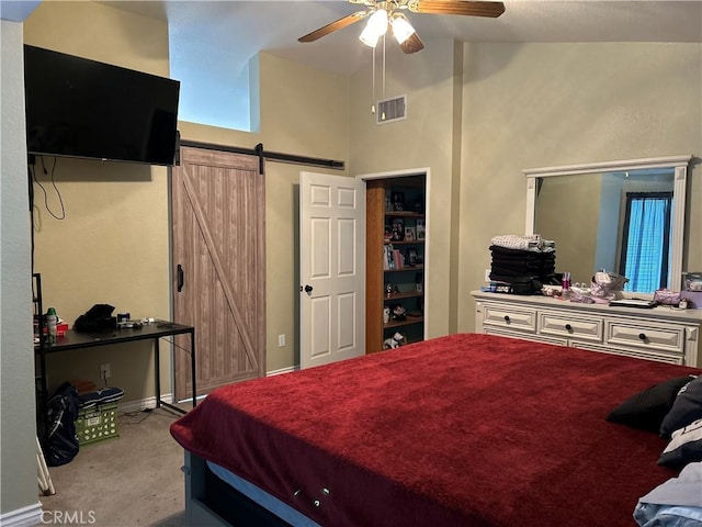 carpeted bedroom featuring a ceiling fan, high vaulted ceiling, visible vents, and a barn door