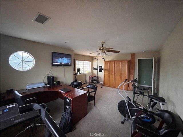 exercise area with a ceiling fan, light colored carpet, and visible vents