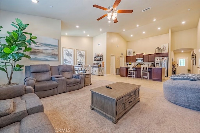 4154 Tudal Ave, Merced, CA 95348 - living area with arched walkways, a ceiling fan, recessed lighting, light colored carpet, and high vaulted ceiling